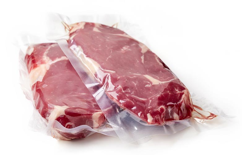 Vacuum sealed fresh beef steak for sous vide cooking isolated on white background